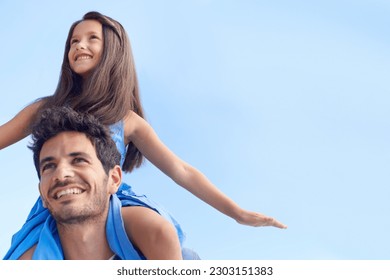 Blue sky, piggyback and happy family dad, kid or people looking at mockup, nature holiday or outdoor view. Fun shoulder ride, freedom and child bonding with dad on travel, vacation or relax walk