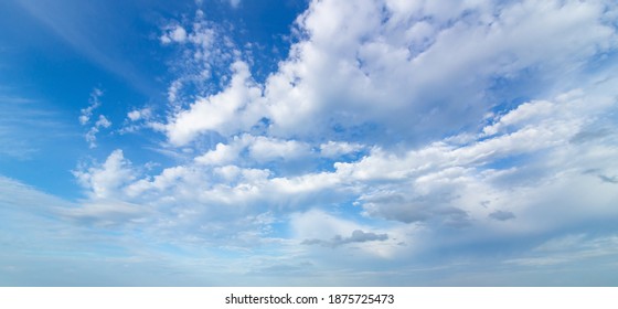 Blue Sky And Puffy Clouds Background