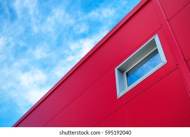 Blue sky, red facade and window