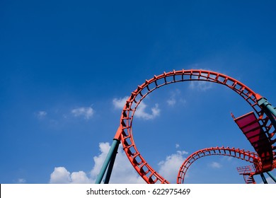 blue sky and red rollercoaster