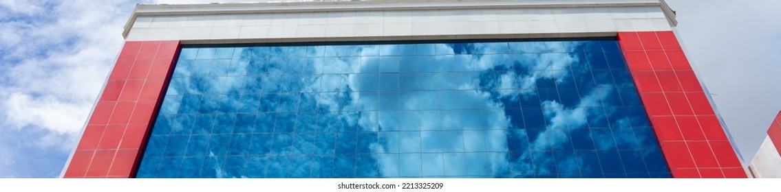 blue sky reflected in the window of a building