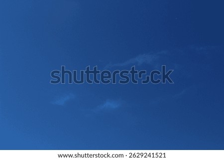 blue sky and small white whisp clouds 