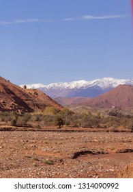 Blue Sky And Snow Covered Atlas Mountains Behind The Sand Dunes In The Sahara Desert