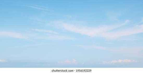 Blue sky in soft white clouds. Beautiful Panoramic Natural cloudscape background, texture for Design. Sky over sea horizon. Wide Angle Delicate Wallpaper or Web banner With Copy Space. - Shutterstock ID 1956192229