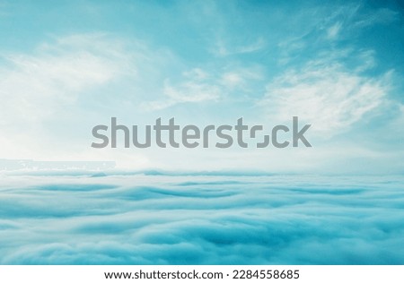 Blue sky with some clouds. View over the clouds.ummer blue sky cloud gradient light white background. Beauty clear cloudy in sunshine calm bright winter air bacground. Gloomy vivid cyan landscape in e