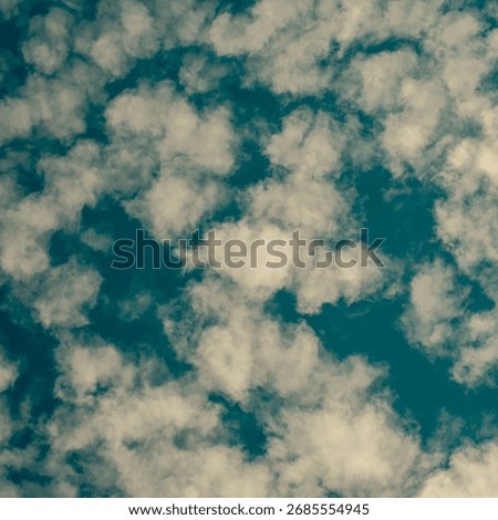 A blue sky with a spattering of cloud.