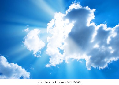 The Blue Sky And Sun Beams Shining Through Clouds