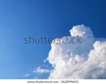 
Blue Sky with Sun Rays and Fluffy White Clouds on a Bright Sunny Day
