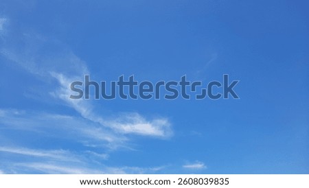 Blue sky with thin white clouds background. The sky is very beautiful and peacefully.