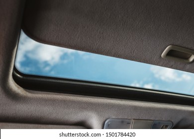 Blue Sky Through An Open Car Sunroof - View From The Passenger Compartment