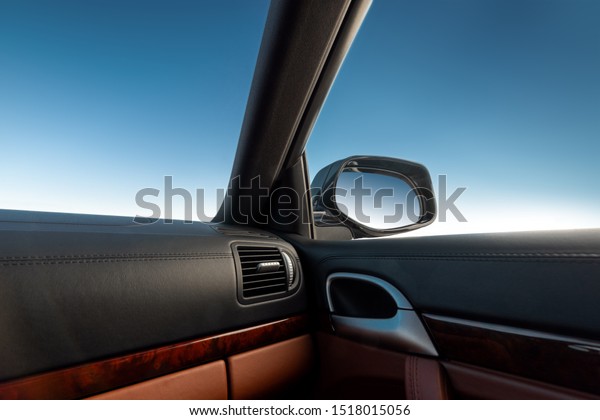 Blue sky\
viewed from inside a car, rear view\
mirror