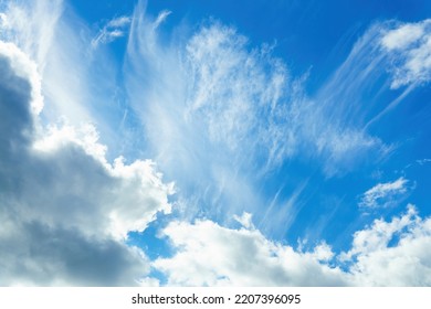 Blue Sky With White Cirrus And Dark Nimbostratus Clouds