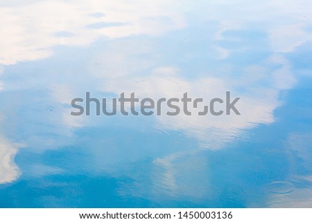 Blue sky and white cloud reflect on the water in a bright day look like impressionist painting, Water reflection abstract background concept