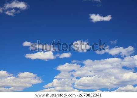 Blue sky white clouds background. White fluffly clouds texture.