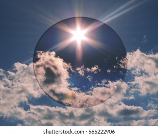 Blue sky with white clouds with a darker circle added.  The sun flares, some sky and clouds are covered which colored it dark