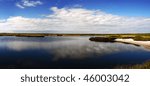 blue sky and white clouds reflection on the blue lake in the plain (tundra) by day in summer