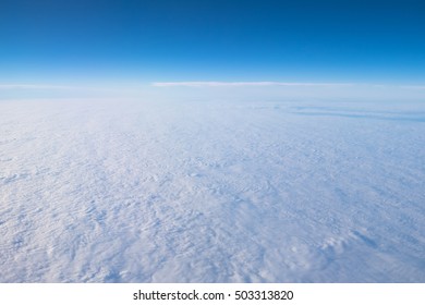 Blue sky and white clouds from the window of an airplane