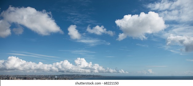 Blue Sky With White Fluffy Clouds At Noon