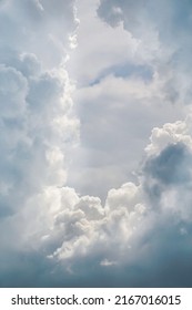 Blue Sky With White Fluffy Cumulus Clouds Close Up.