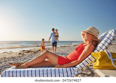 Blue sky, woman and relax chair at beach with family adventure, sunshine and bonding in summer holiday together. Happy, mother and resting by ocean, travel and freedom of tropical vacation in Greece - Powered by Shutterstock