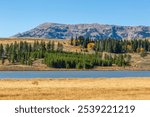 Blue sky, yellow meadows, rivers, the scenery of The Gallatin Range in early autumn. -Yellowstone National Park, Wyoming, ⁩⁨‎⁨United States.⁩⁨ 