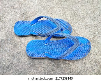 Blue slippers sandals beach shoes isolated on a ground background. Summer travel concept