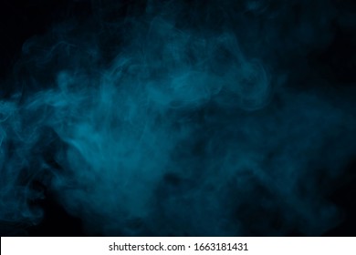 Blue smoke effect on a black background in a studio
