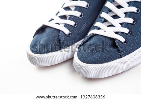 blue sneakers on white background with copy space. Youth shoes. close up