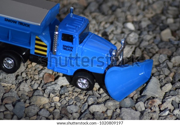 Blue snow truck plower\
toy.