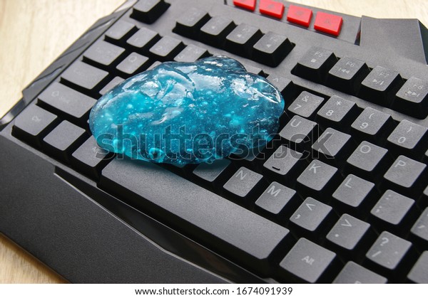 Blue soft gel cleaning dust on\
keyboard. Concept cleaning your computer\'s\
keyboard.