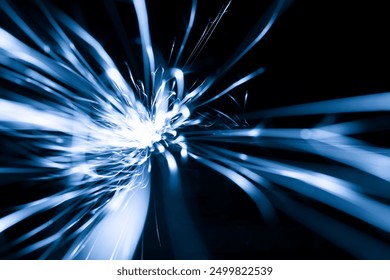 blue sparks from the grinder glowing in the dark straight ahead - Powered by Shutterstock