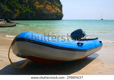 blue speed boat inflatable on beach