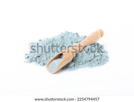 Blue spirulina powder in spoon isolated on white background. Natural vegan superfood. food supplement.