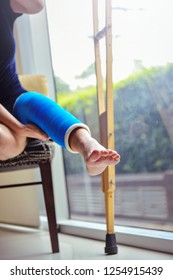 Blue Splint Knee. Bandaged Leg Cast And Toes After A Running Injury Accident.Young Woman In Blue Plaster Cast. Cropped Shot Of A Girl Holding Her Leg In Pain. Shin Splints.