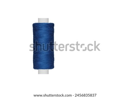 blue spool of sewing thread isolated on white background close up