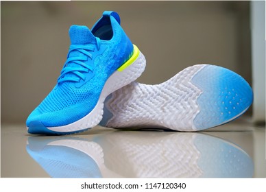 Blue Sport Shoes For Running On Blur Background