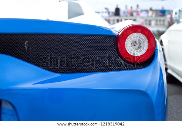 blue sports\
car spot light. Detail of a luxury\
car