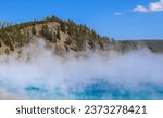 Blue spring with steam at Mud Volcano in Yellowstone National Park