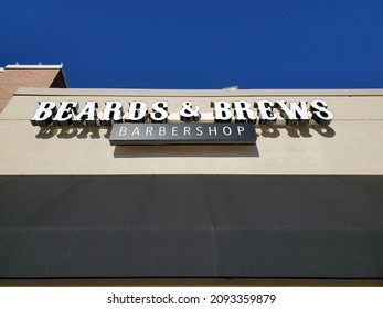 Blue Springs Missouri USA - December 16 2021: Sign Above Building Entrance For BEARDS And BREWS BARBER SHOP Beneath Blue Sky