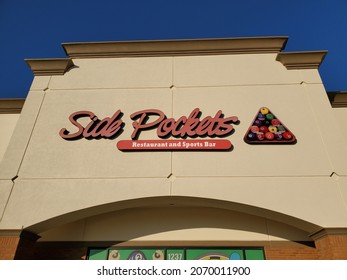 Blue Springs, Missouri USA - November 5 2021: Sign For Side Pockets Restaurant And Sports Bar Above Building Entrance Beneath Blue Sky