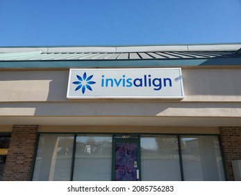 Blue Springs Missouri USA - November 21 2021: Sign For Invisalign Above Entrance Beneath Blue Sky