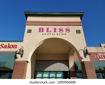 Blue Springs Missouri USA - November 21 2021: Sign for BLISS CHOCOLATIER above Building Entrance beneath Blue Sky