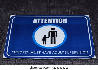 Blue square attention sign usually at the swimming pool, playground area, or any danger potential area for children. - Shutterstock ID 2239326113