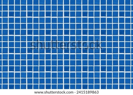 Blue square ceramic tile background. Swimming pool texture. Geometric wall decoration. Home bathroom floor. Ornamental patchwork. Simple square design. White fugue grid.