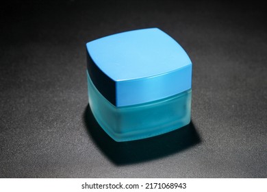 Blue Square Cosmetic Bottle In Low Light Photo Studio Studio