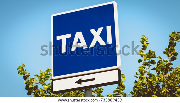blue square sign indicating a taxi wire in\
barcelona, spain