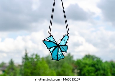 Blue Stained Glass Sun Catcher Hanging On Window