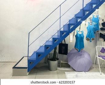 The blue stairs with swimwear, umbrellas and put under the stairs. As background image. - Powered by Shutterstock