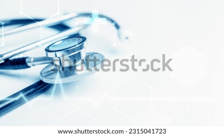 Blue stethoscope on white table background with copy space and EKG heart rate pulse wave monitor. Healthcare and medical concept. Diagnose equipment and instrument tools in hospital clinic theme.