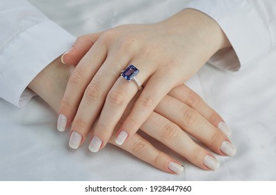 The blue stone diamond ring is on a lady finger. A very expensive custom ring. - Shutterstock ID 1928447960